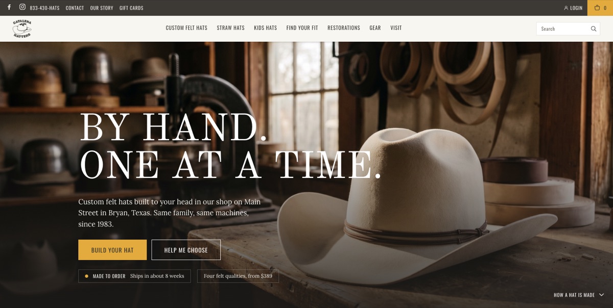 The redesigned homepage on desktop: a workshop photograph with a silverbelly Gus on a workbench, the headline By hand. One at a time., one line about the shop, a gold Build your hat button, and a chip reading Made to order, ships in about 8 weeks. Opens in a new tab.