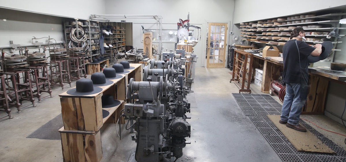 Inside the Catalena workshop: hat blocks and pressing machines in a long row