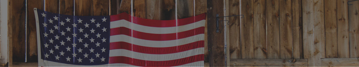 American flag hanging on a barn-wood wall