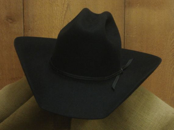 Black All Around felt hat with a wide brim against wood paneling