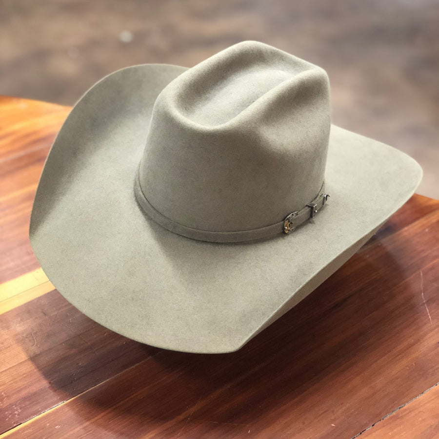 Natural-colored felt hat resting on a wooden floor
